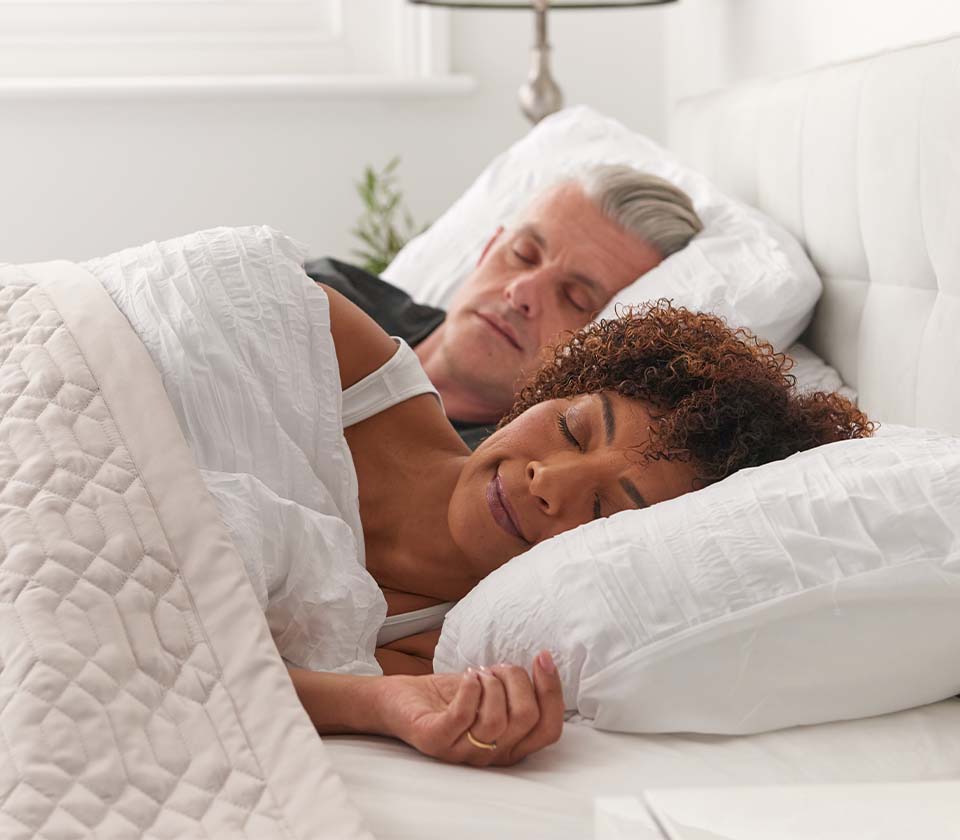 40 year old couple in bed sleeping restfully